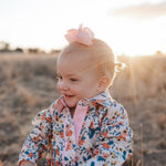 Milla floral dream long sleeve romper back view showing snap closure and beautiful floral dream print