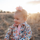 Milla floral dream long sleeve romper back view showing snap closure and beautiful floral dream print