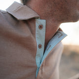 Clay Guy dust brown men's polo shirt back view showing relaxed men's fit in dust brown