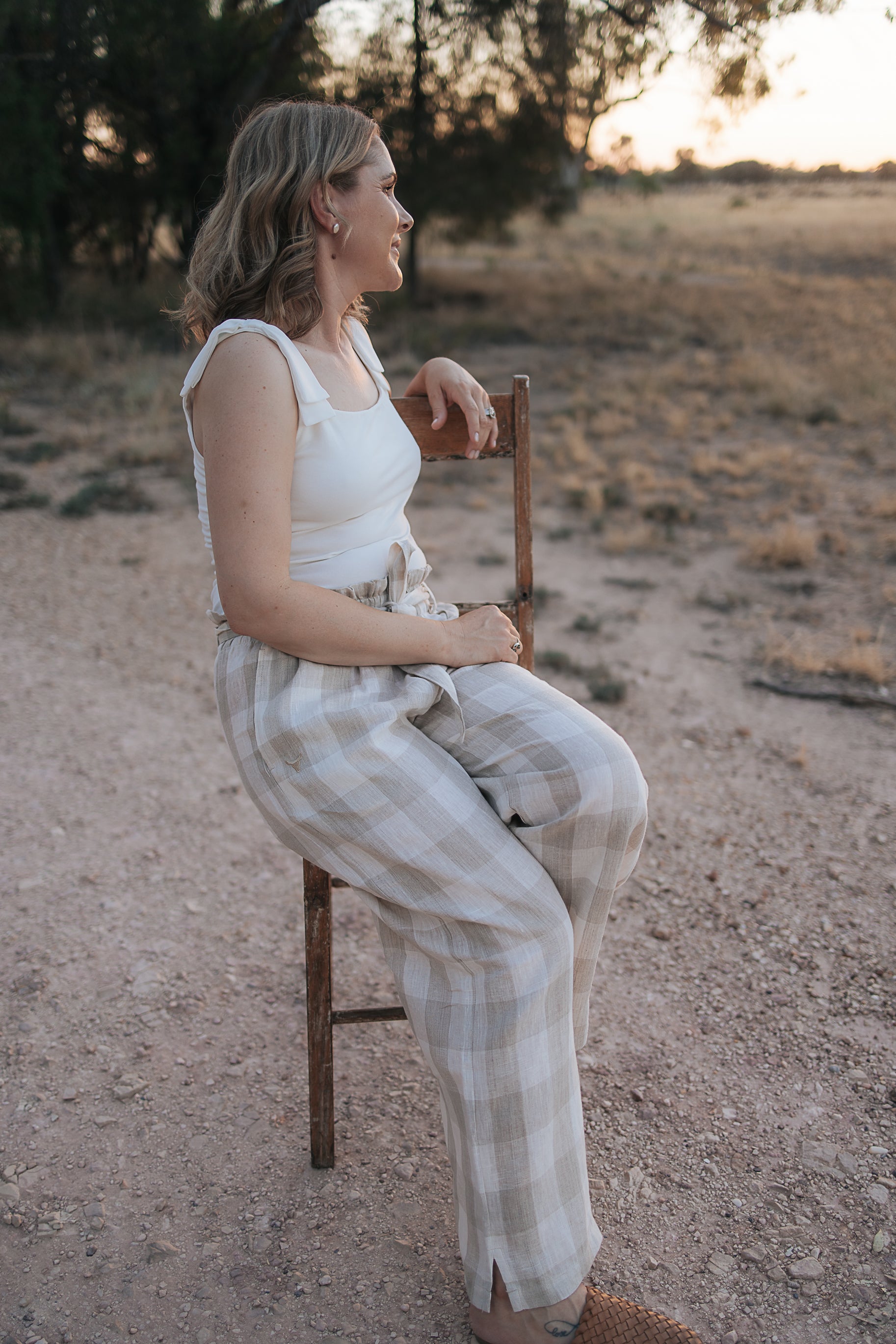 Latte Luci ladies linen pants side view showing relaxed wide leg silhouette in latte linen