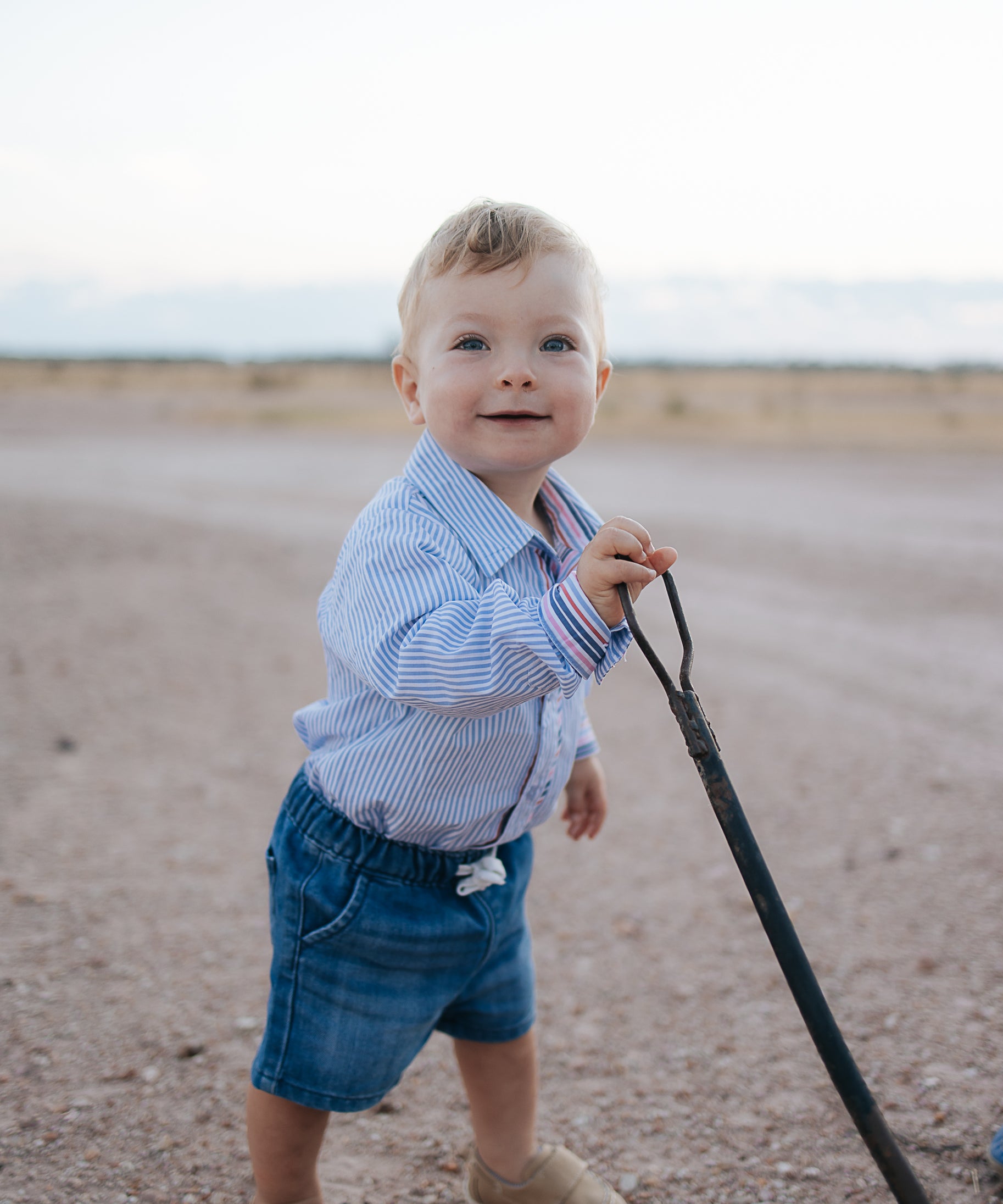 Rhett multi stripe blue long sleeve romper worn showing vibrant multi stripe blue country style