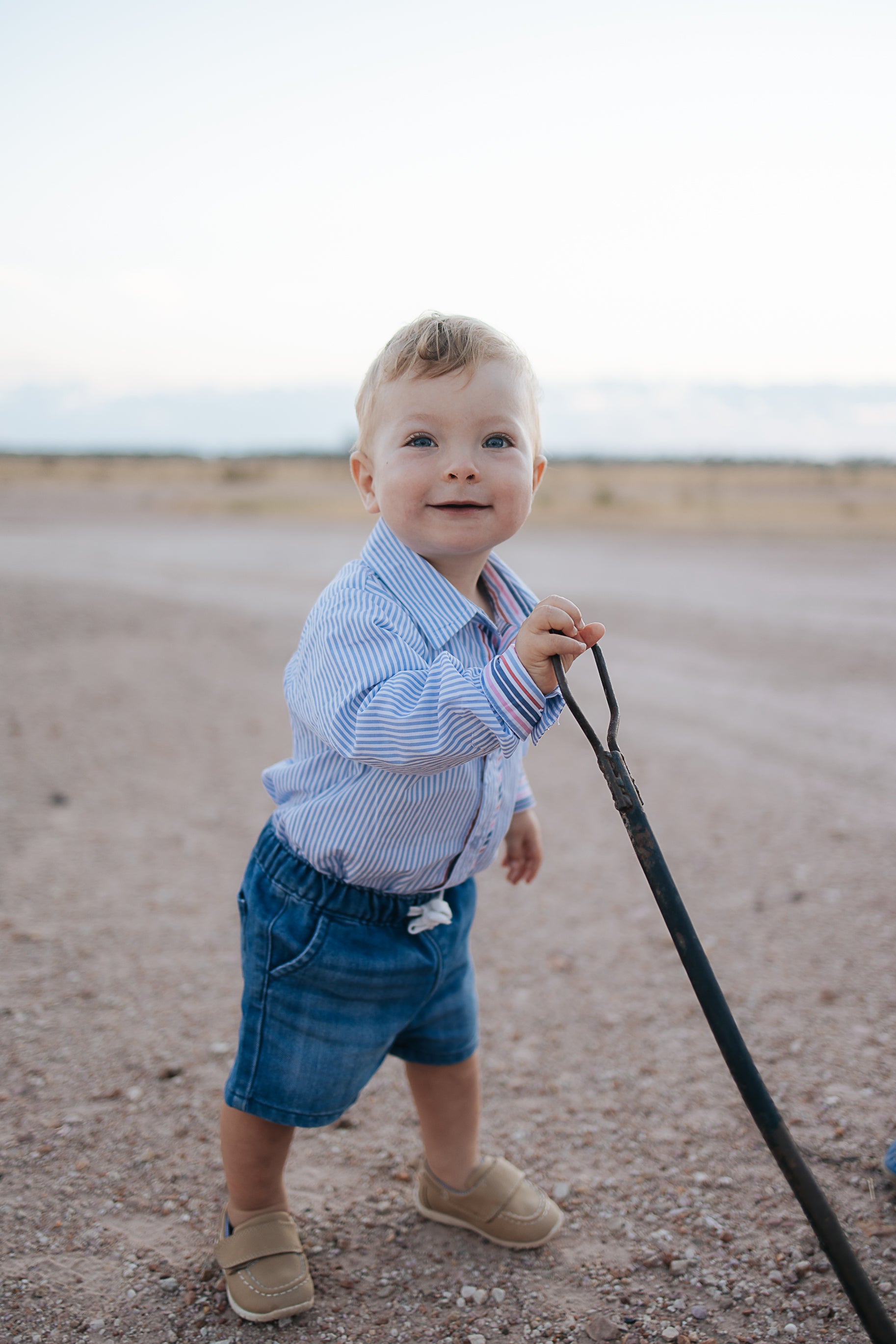 Rhett multi stripe blue long sleeve romper worn showing vibrant multi stripe blue country style