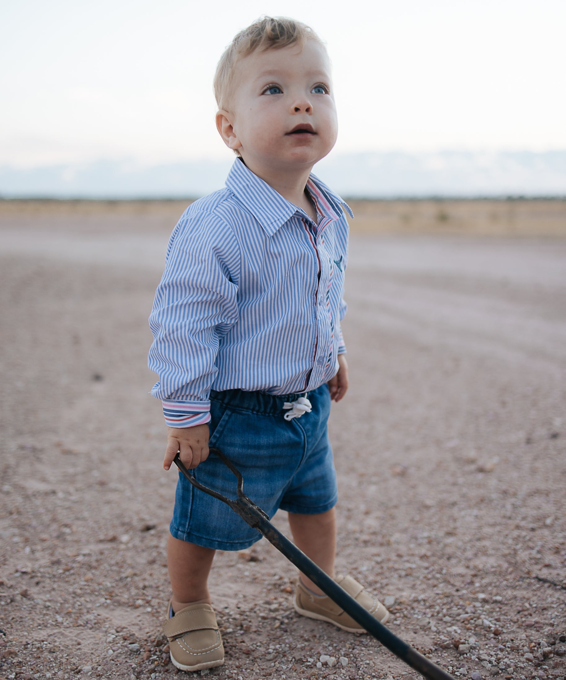 Rhett multi stripe blue long sleeve romper front view showing bold multi stripe blue romper for kids