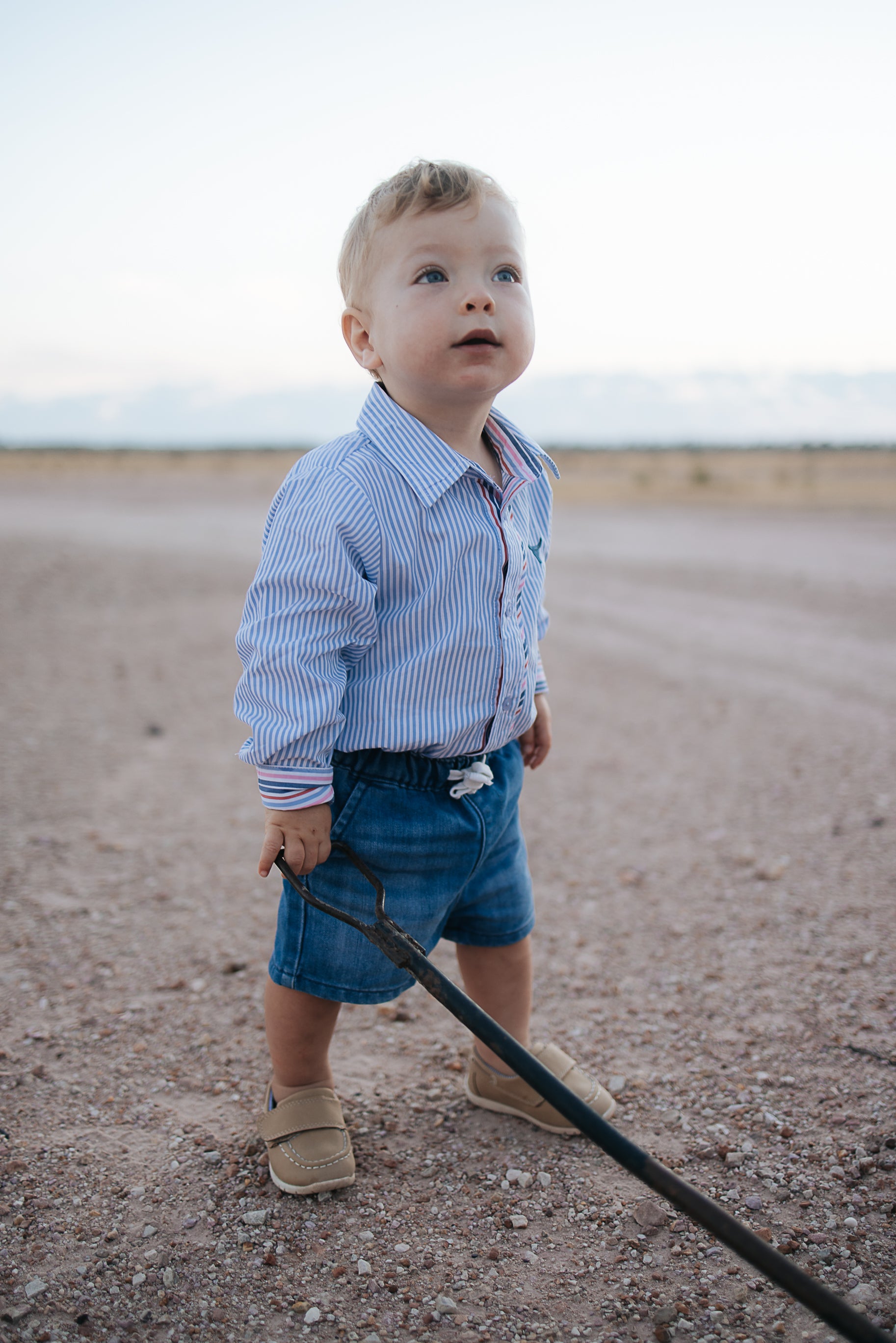 Rhett multi stripe blue long sleeve romper front view showing bold multi stripe blue romper for kids