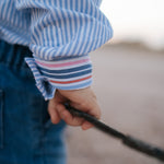 Rhett multi stripe blue long sleeve romper back view showing snap closure and multi stripe blue design