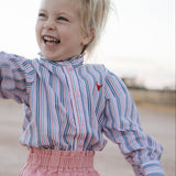 Lauren multi stripe pink ruffle long sleeve shirt back view showing relaxed women's fit in pink stripe