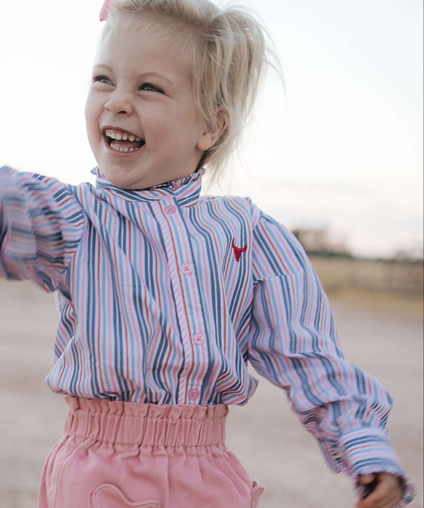Lauren multi stripe pink ruffle long sleeve shirt back view showing relaxed women's fit in pink stripe