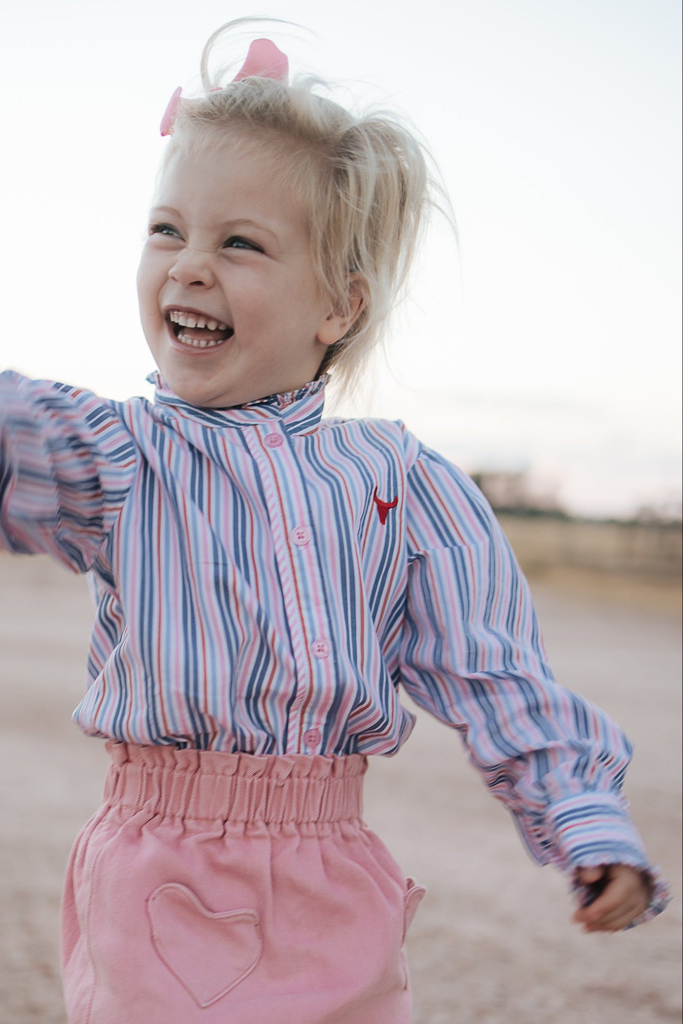Lauren multi stripe pink ruffle long sleeve shirt back view showing relaxed women's fit in pink stripe