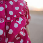 Kansas polkadot pink short sleeve blouse worn by girl showing sweet playful pink polkadot style