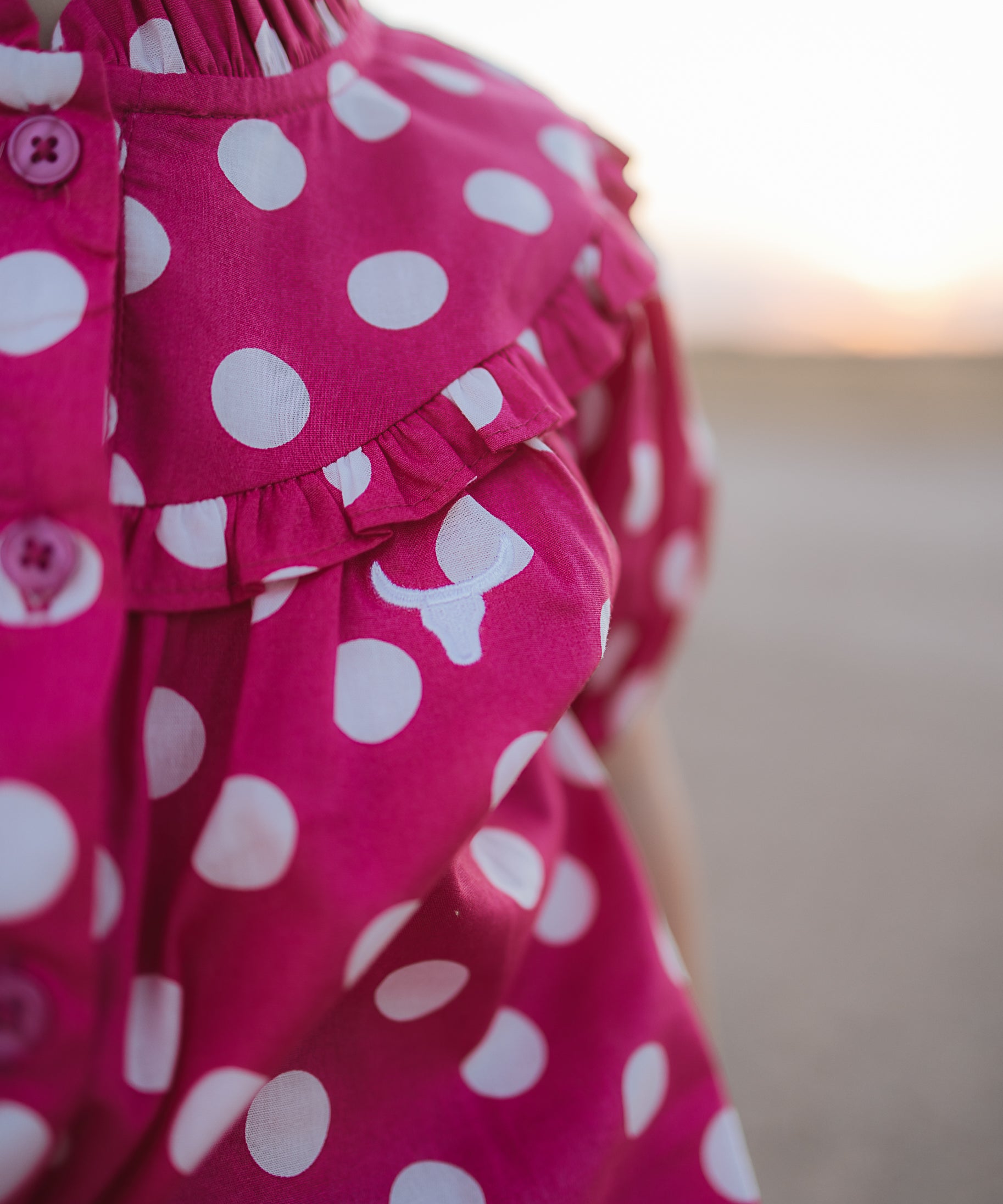 Kansas polkadot pink short sleeve blouse worn by girl showing sweet playful pink polkadot style