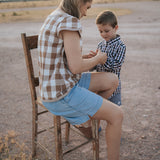 Dusty gingham women's blouse side view showing relaxed feminine shirt silhouette