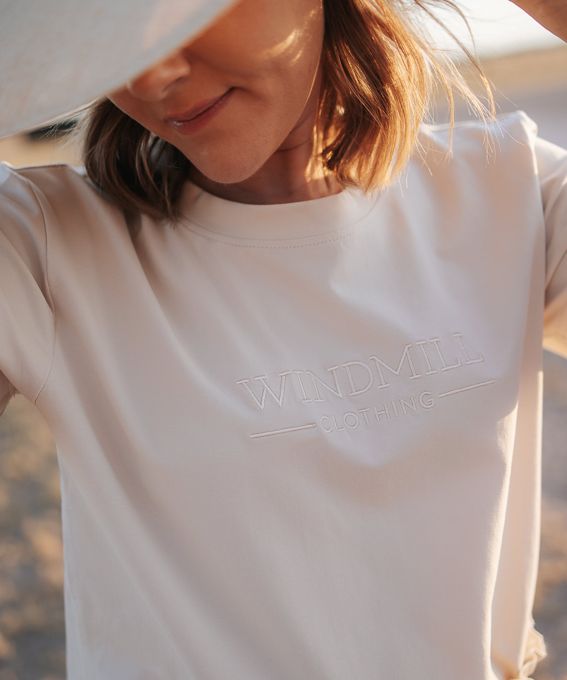 LWCC embroidered ladies tee beige front view showing signature LWCC embroidered logo on classic beige
