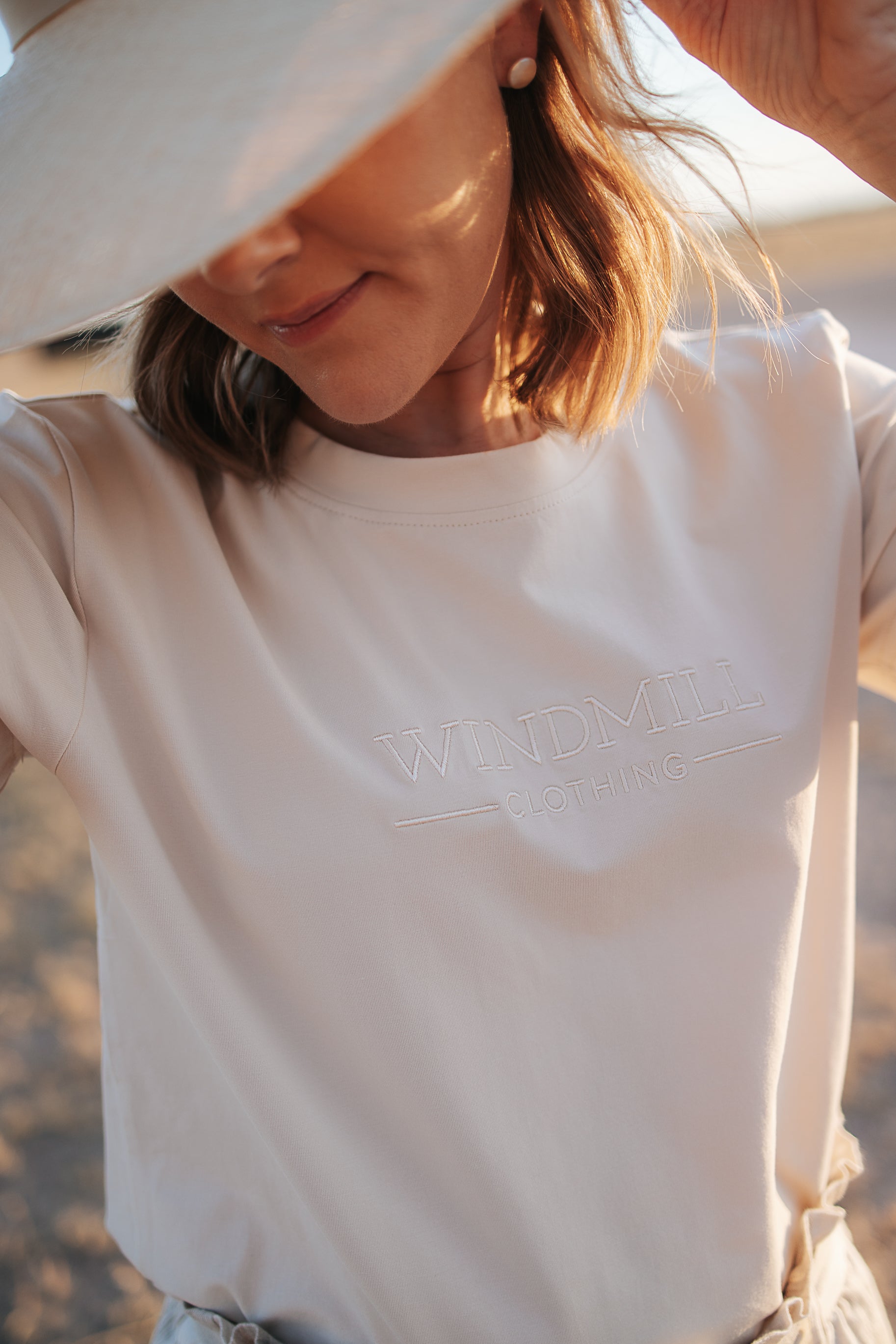 LWCC embroidered ladies tee beige front view showing signature LWCC embroidered logo on classic beige