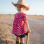 Kansas polkadot pink short sleeve blouse back view showing relaxed girls fit in pink polkadot