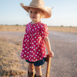 Kansas polkadot pink short sleeve blouse back view showing relaxed girls fit in pink polkadot