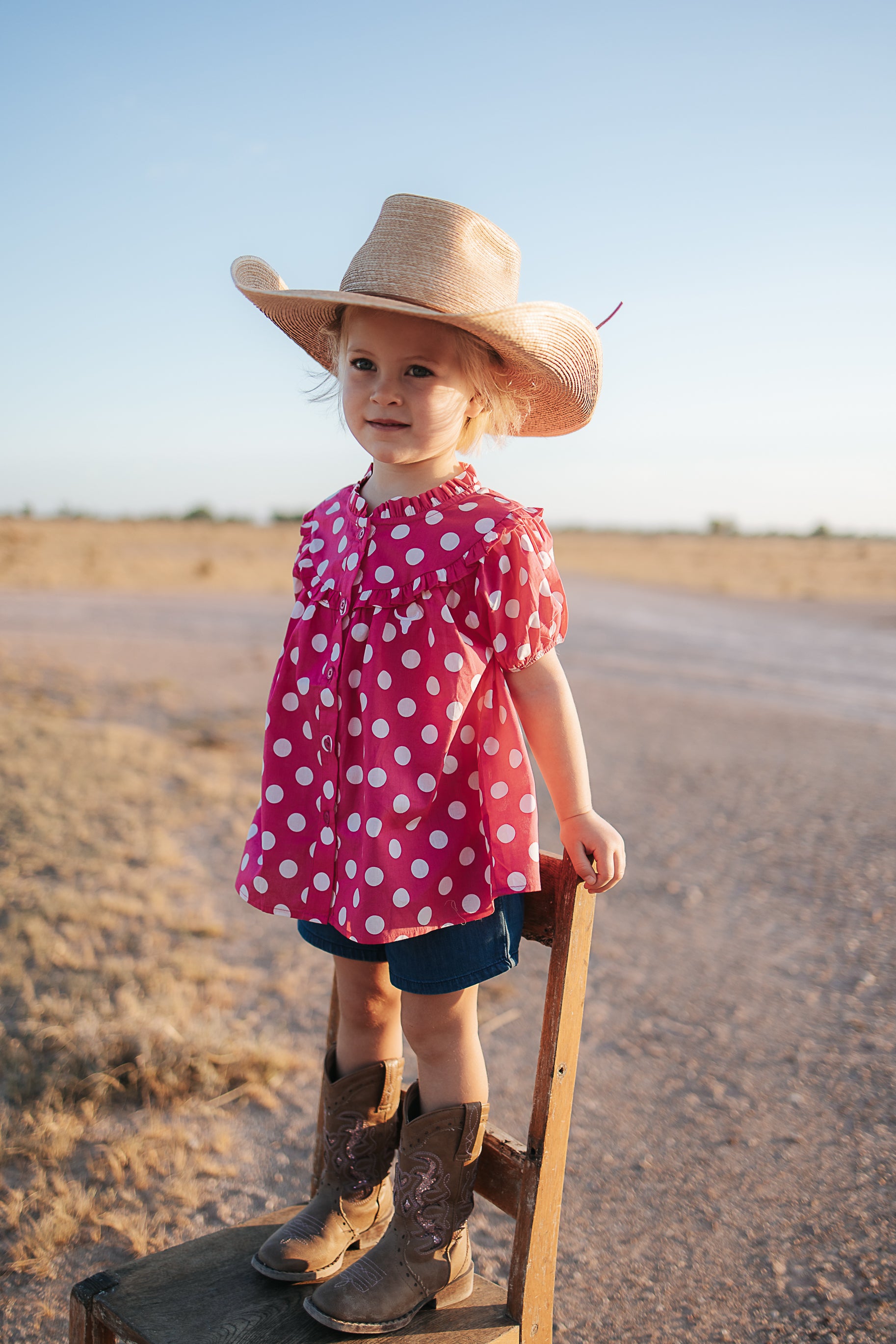 Kansas polkadot pink short sleeve blouse back view showing relaxed girls fit in pink polkadot