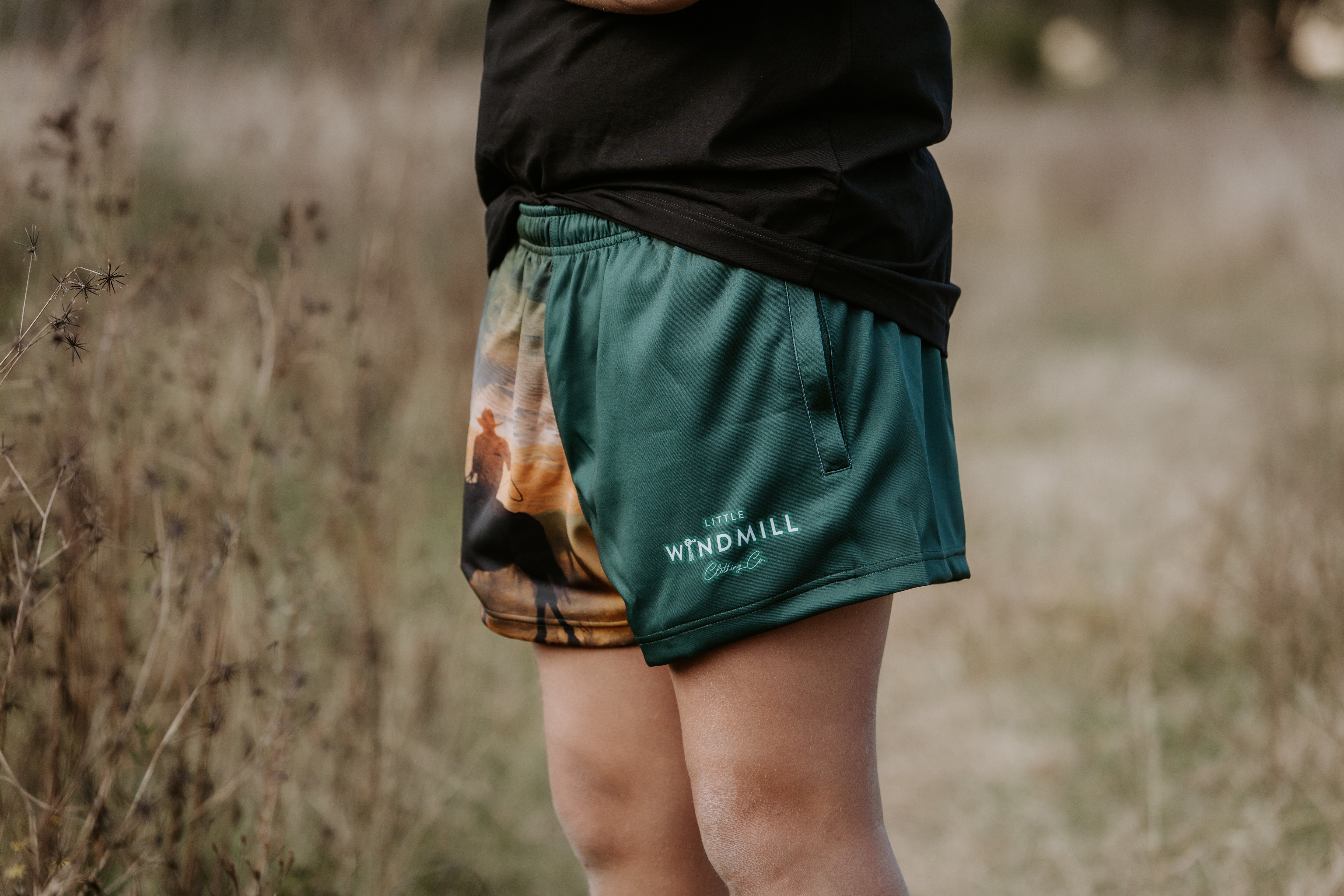 Moss green men's footy shorts front view showing relaxed fit in fresh moss green
