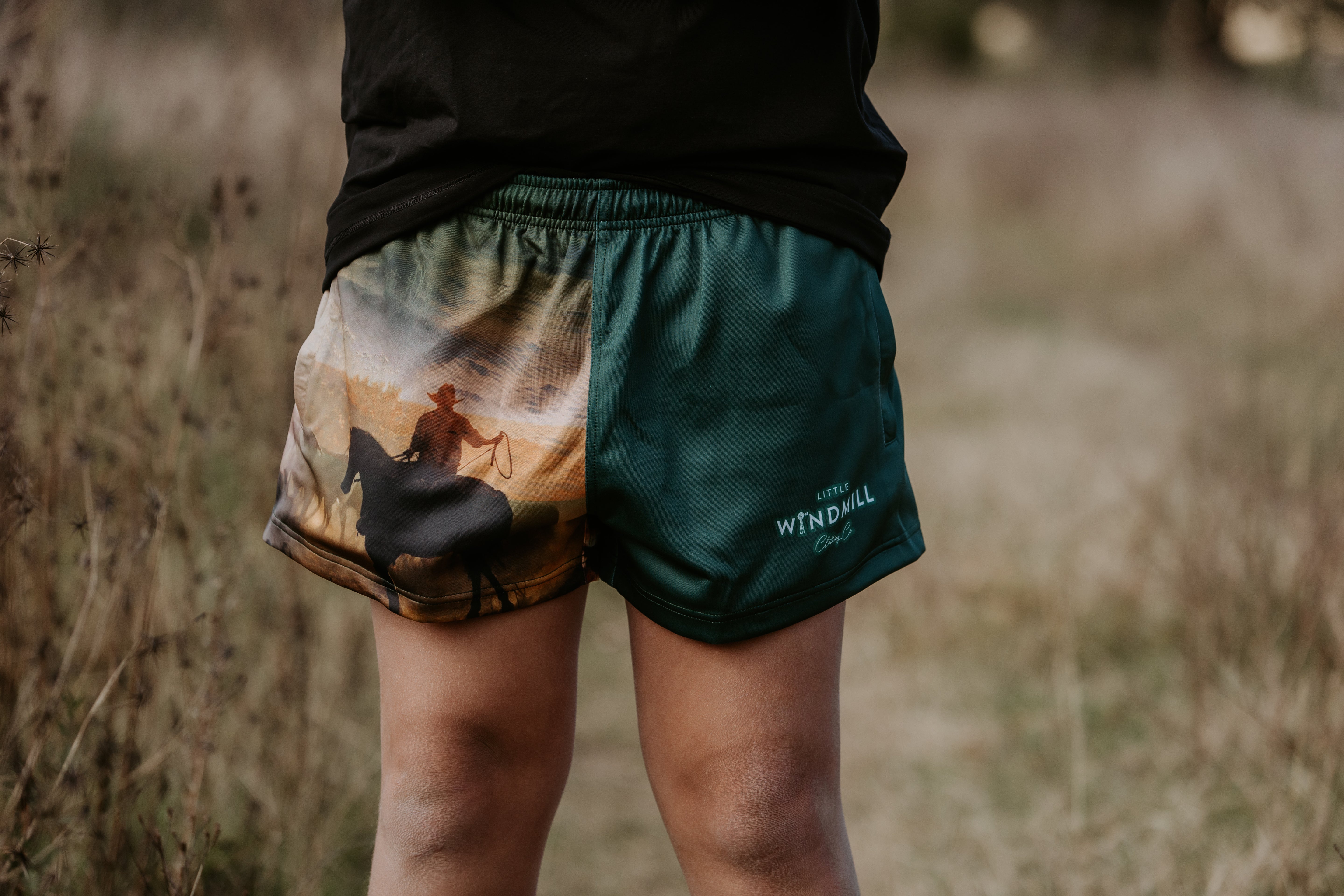 Moss green footy shorts side view showing comfortable cut and moss green colourway