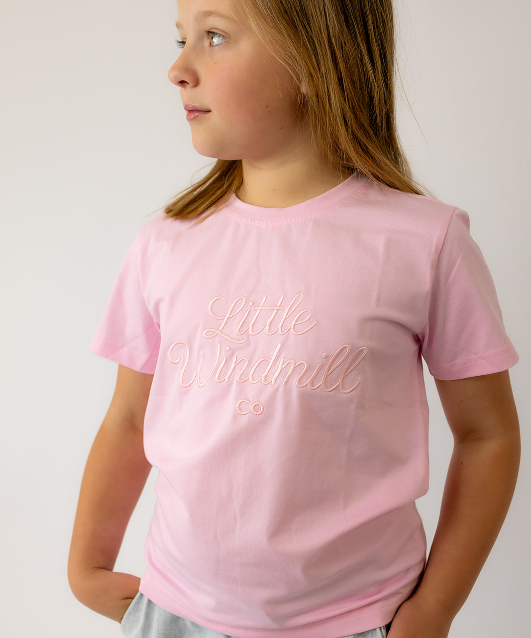 LIMITED EDITION embroidered kids tee soft pink worn by child showing boutique quality and sweet pink style