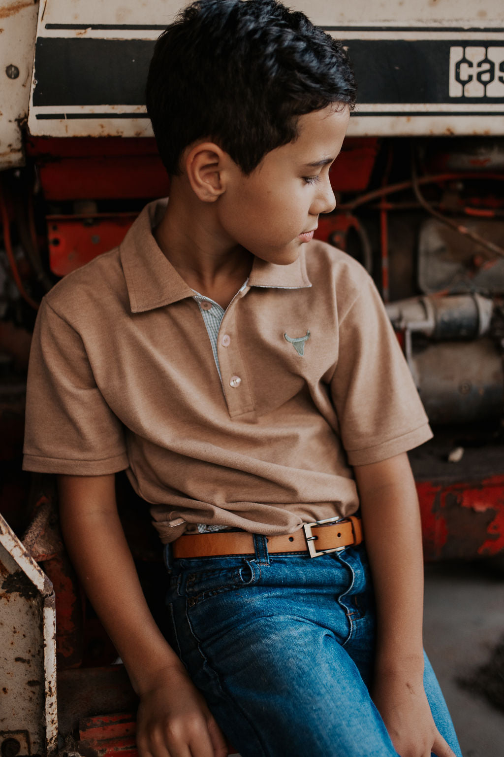 Clayton caramel polo hem detail showing classic boys polo finishing