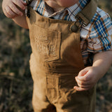 Blaze brown overalls strap detail showing adjustable buckle hardware