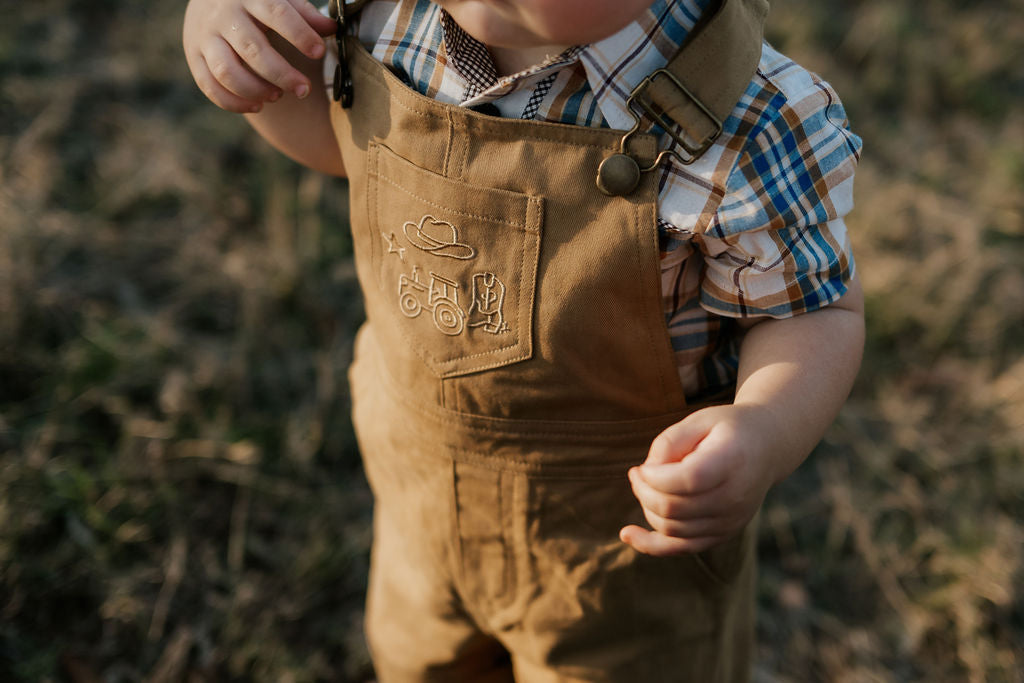 Blaze brown overalls strap detail showing adjustable buckle hardware