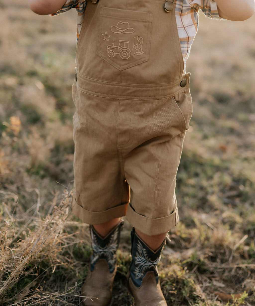 Blaze brown overalls back view showing adjustable strap and quality brown denim