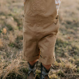 Blaze brown overalls back view showing adjustable strap and quality brown denim