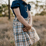 Georgia dark denim check swing dress flatlay showing full A-line swing design in dark denim check