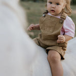 Blaze brown overalls side view showing relaxed leg cut and brown denim