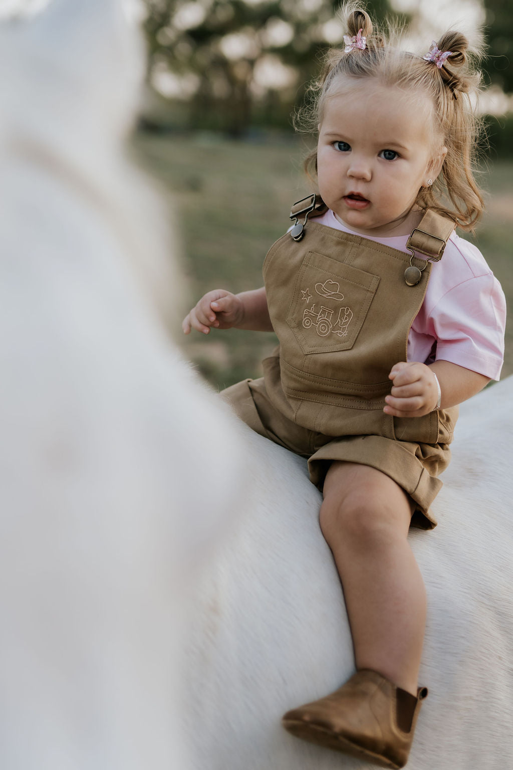 Blaze brown overalls side view showing relaxed leg cut and brown denim