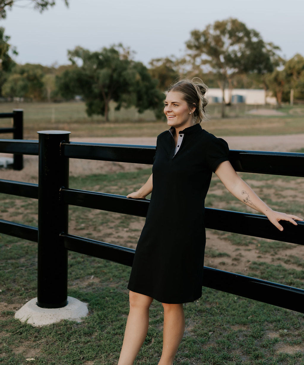 Shay semi-fitted women's black polo dress front view showing sleek black polo neck dress