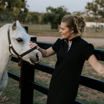 Shay semi-fitted women's black polo dress flatlay showing full dress design in timeless black