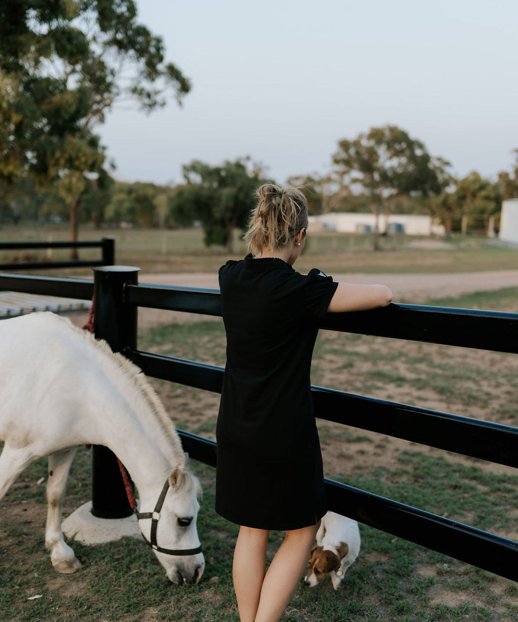 Shay semi-fitted women's black polo dress worn showing polished versatile women's country style