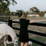Shay semi-fitted women's black polo dress worn showing polished versatile women's country style