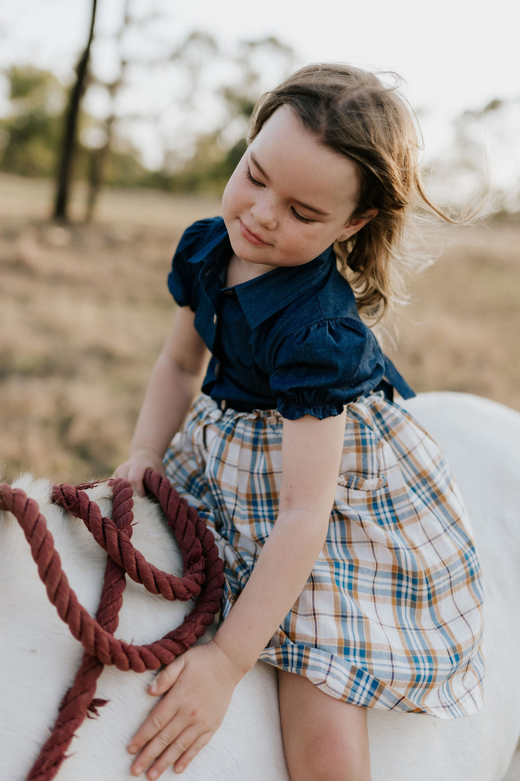 Georgia dark denim check swing dress worn by girl showing sweet country style swing dress