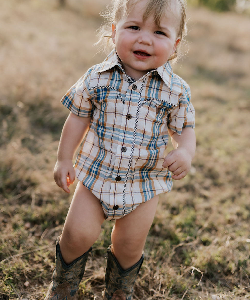 Dallas checked tan short sleeve romper back view showing snap closure and neat tan check fabric