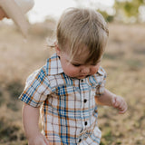 Dallas checked tan short sleeve romper worn by toddler showing sweet western country style