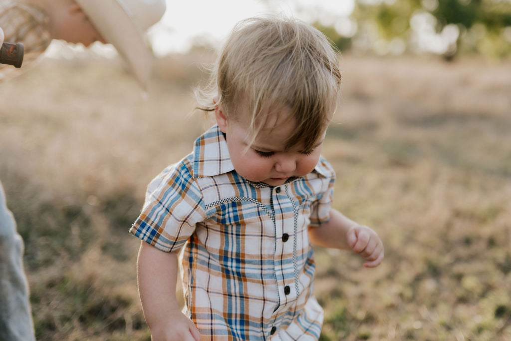 Dallas checked tan short sleeve romper worn by toddler showing sweet western country style