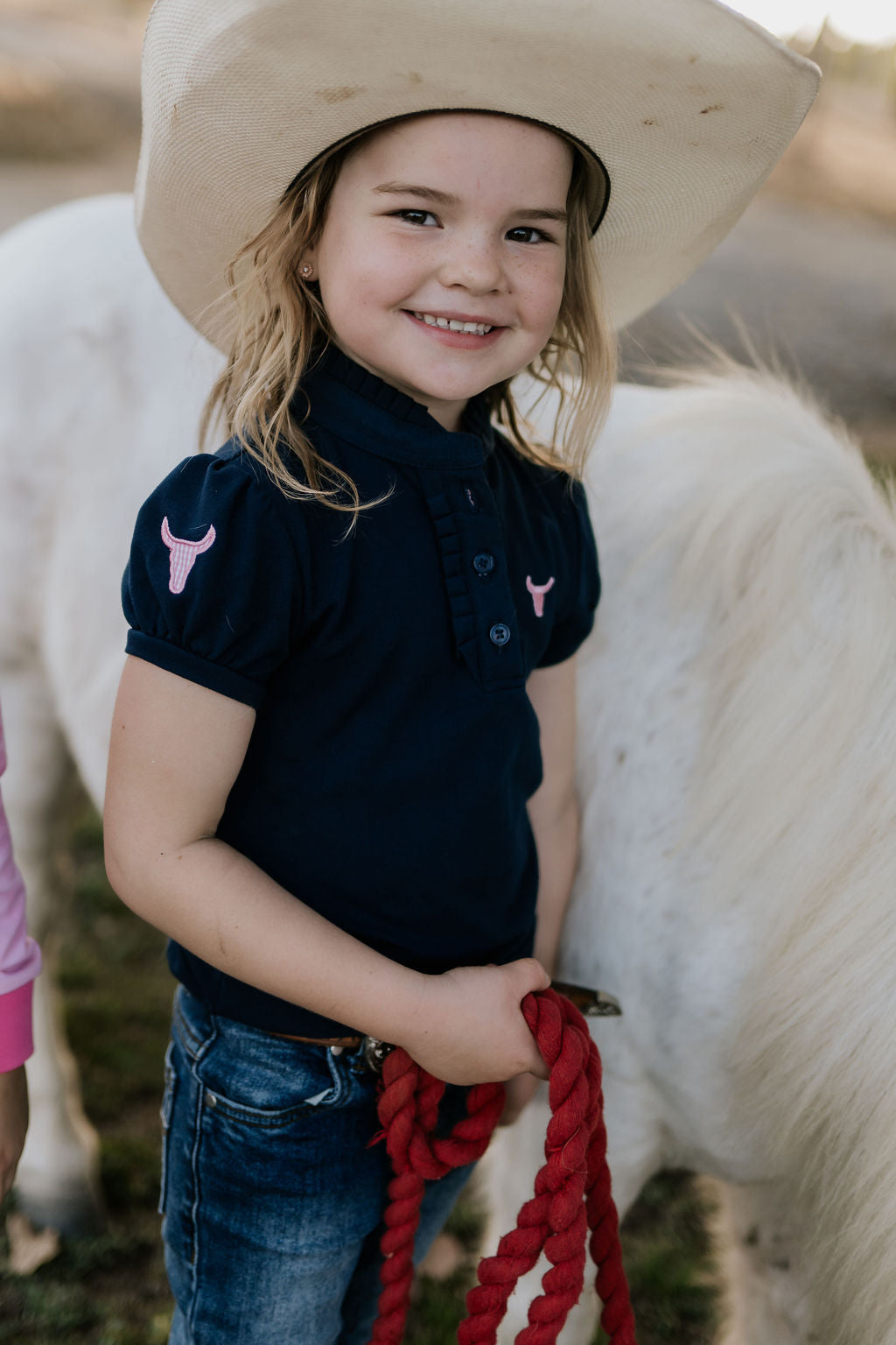Leah classic navy ruffle polo front view showing elegant ruffle collar in classic navy with sophisticated detail