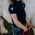 Leah classic navy ruffle polo worn by woman showing timeless country elegant style