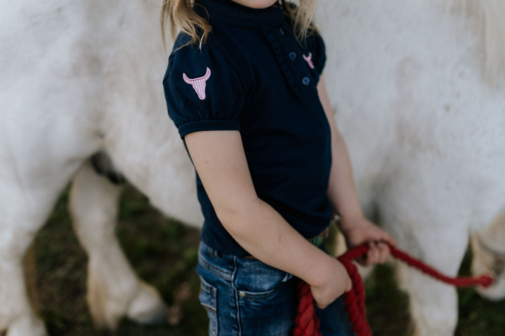 Leah classic navy ruffle polo worn by woman showing timeless country elegant style