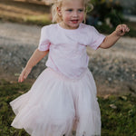 LIMITED EDITION embroidered kids tee soft pink embroidery close-up showing detailed LWCC logo stitch