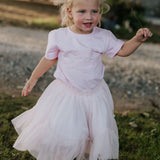 LIMITED EDITION embroidered kids tee soft pink embroidery close-up showing detailed LWCC logo stitch