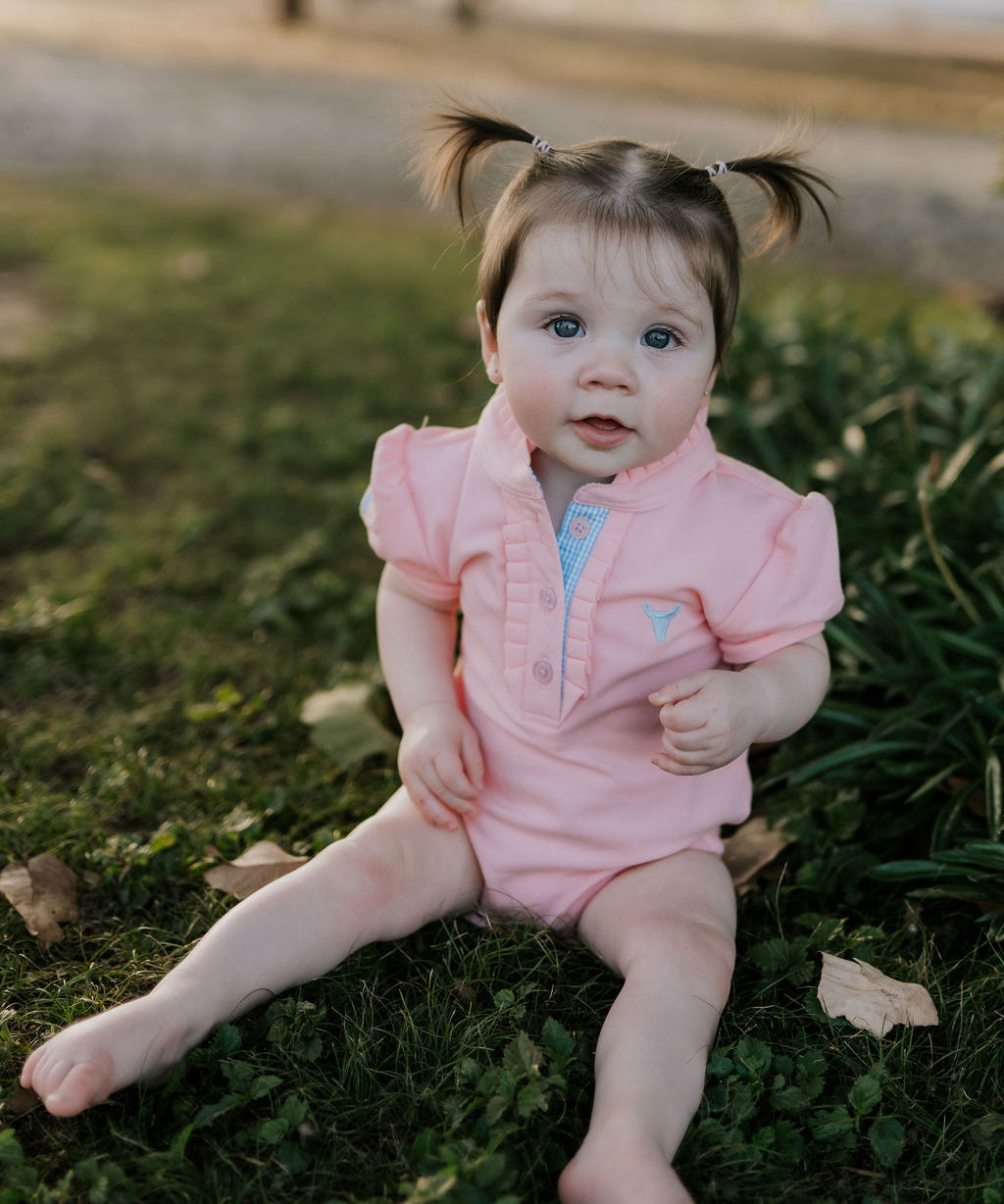 Kiki Baby pink polo romper back view showing snap button closure for easy dressing
