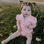 Kiki Baby pink polo romper back view showing snap button closure for easy dressing