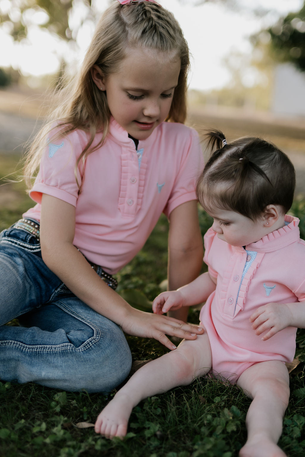 Keira ruffle polo collar close-up showing beautiful ruffle detail in soft baby pink