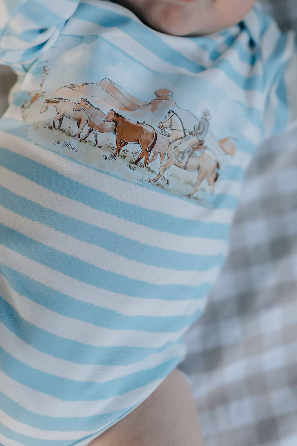 Colt blue stripe jumpsuit collar and button detail close-up showing quality cotton construction