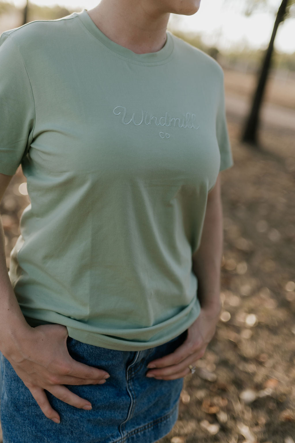 LIMITED EDITION embroidered ladies tee sage flat lay showing full design and serene sage colourway