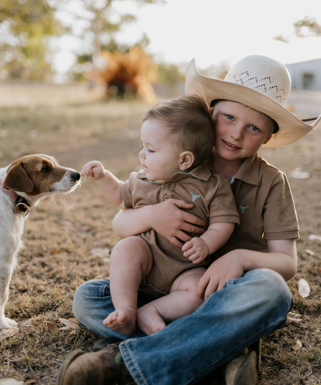 Clay Baby caramel romper worn by baby showing sweet country neutral style